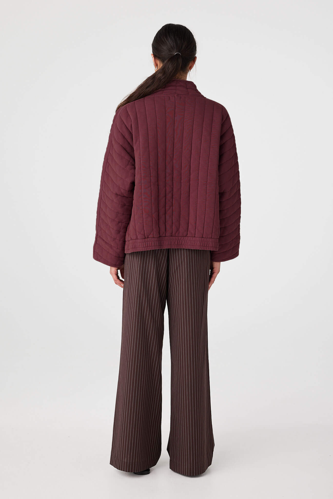 Back view of Merlot quilted jacket showing relaxed width and quilted stitching pattern