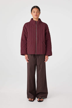 Merlot quilted zip jacket layered over tank top for air-conditioned spaces and travel