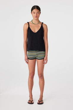 Front view of model wearing black relaxed linen organic cotton tank with twist straps and V-neckline