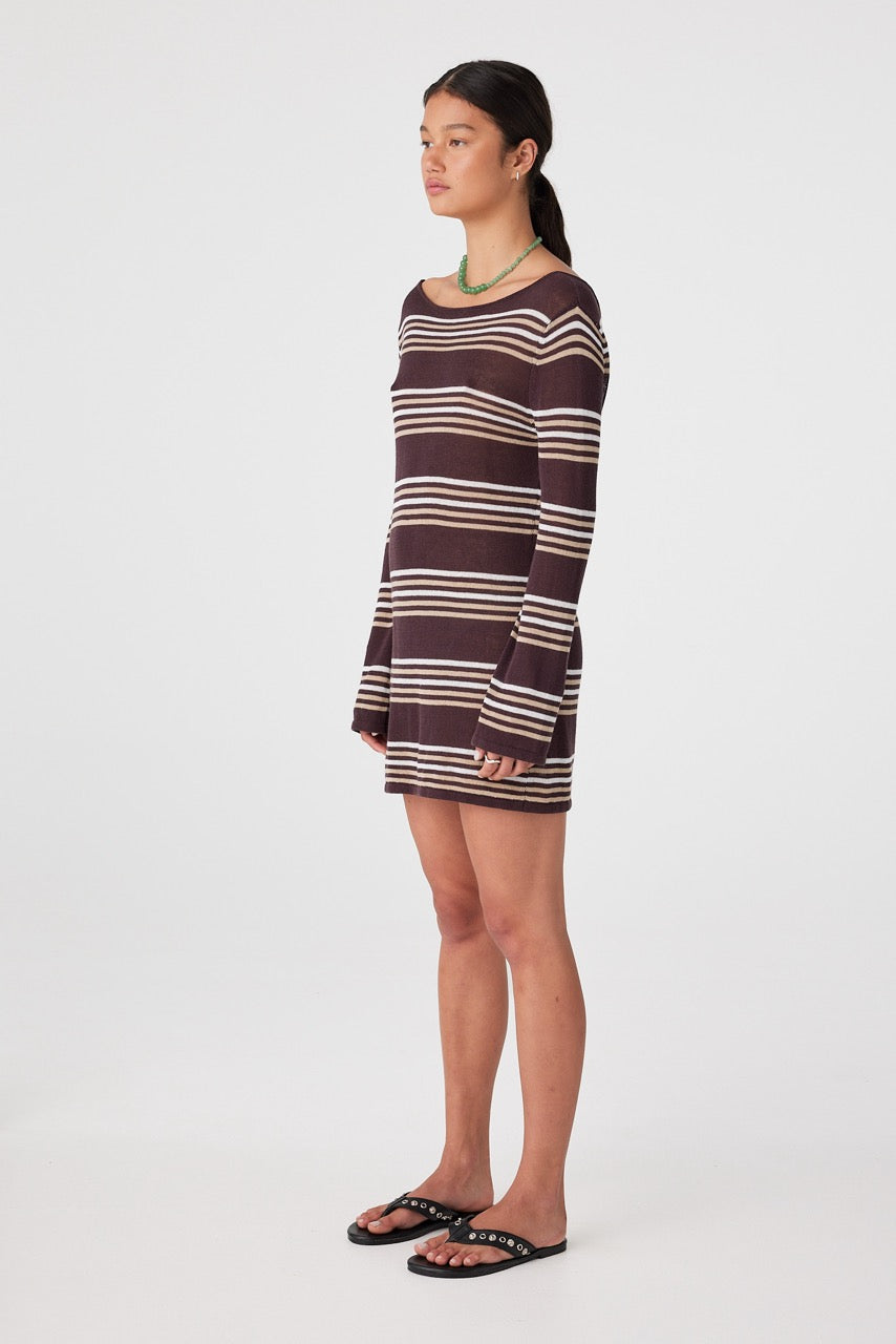 Side profile of woman in espresso stripe long-sleeve mini dress showing loose fit