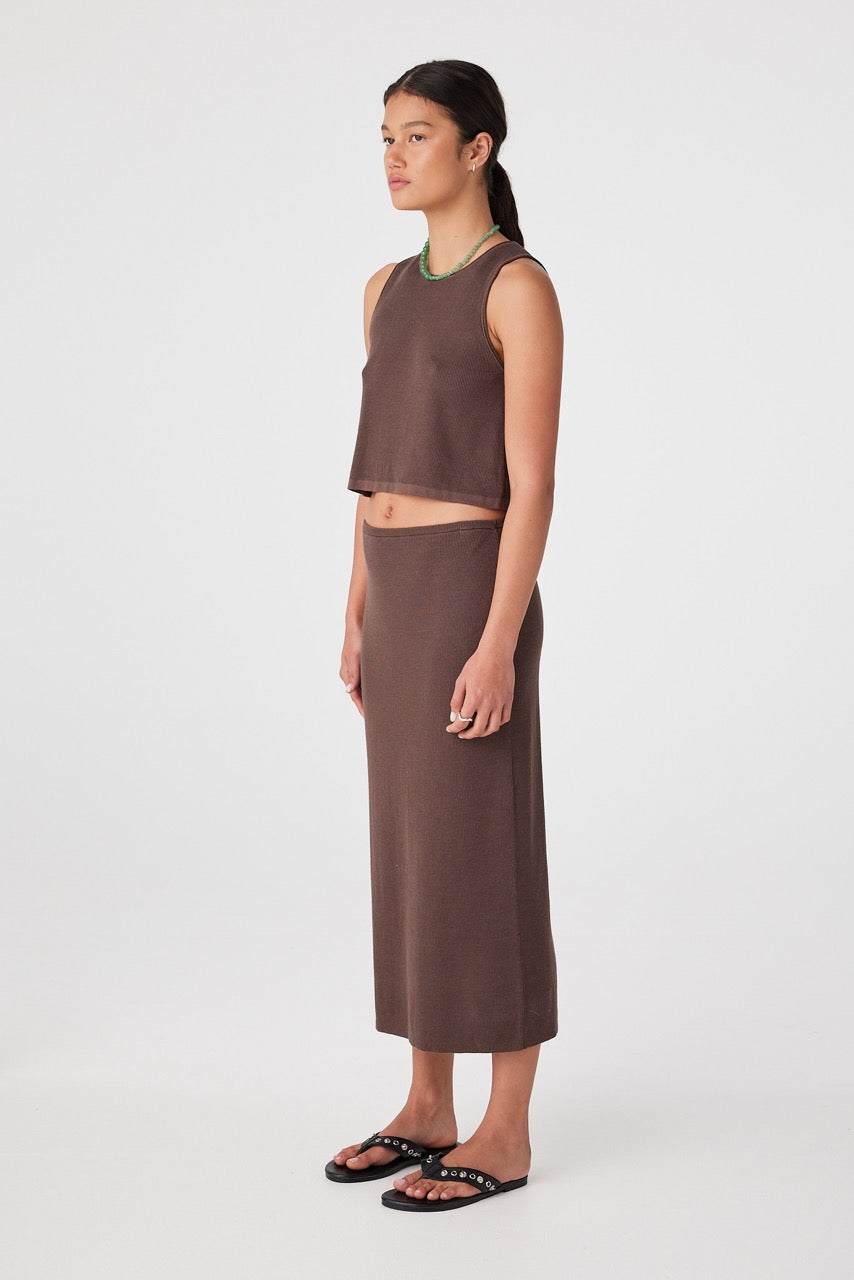 Side profile of woman in espresso rib longline skirt showing column shape