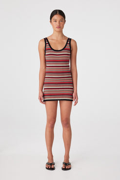 Model wearing slim-fit cotton knit mini dress in Flame Stripe with scoop neckline and sleeveless cut