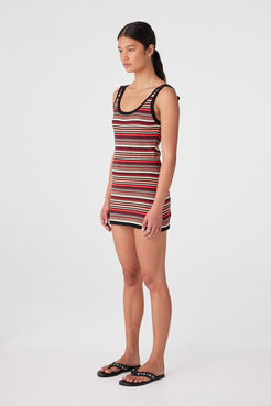 Side view of fitted cotton knit dress showing body-skimming silhouette and above-knee hem