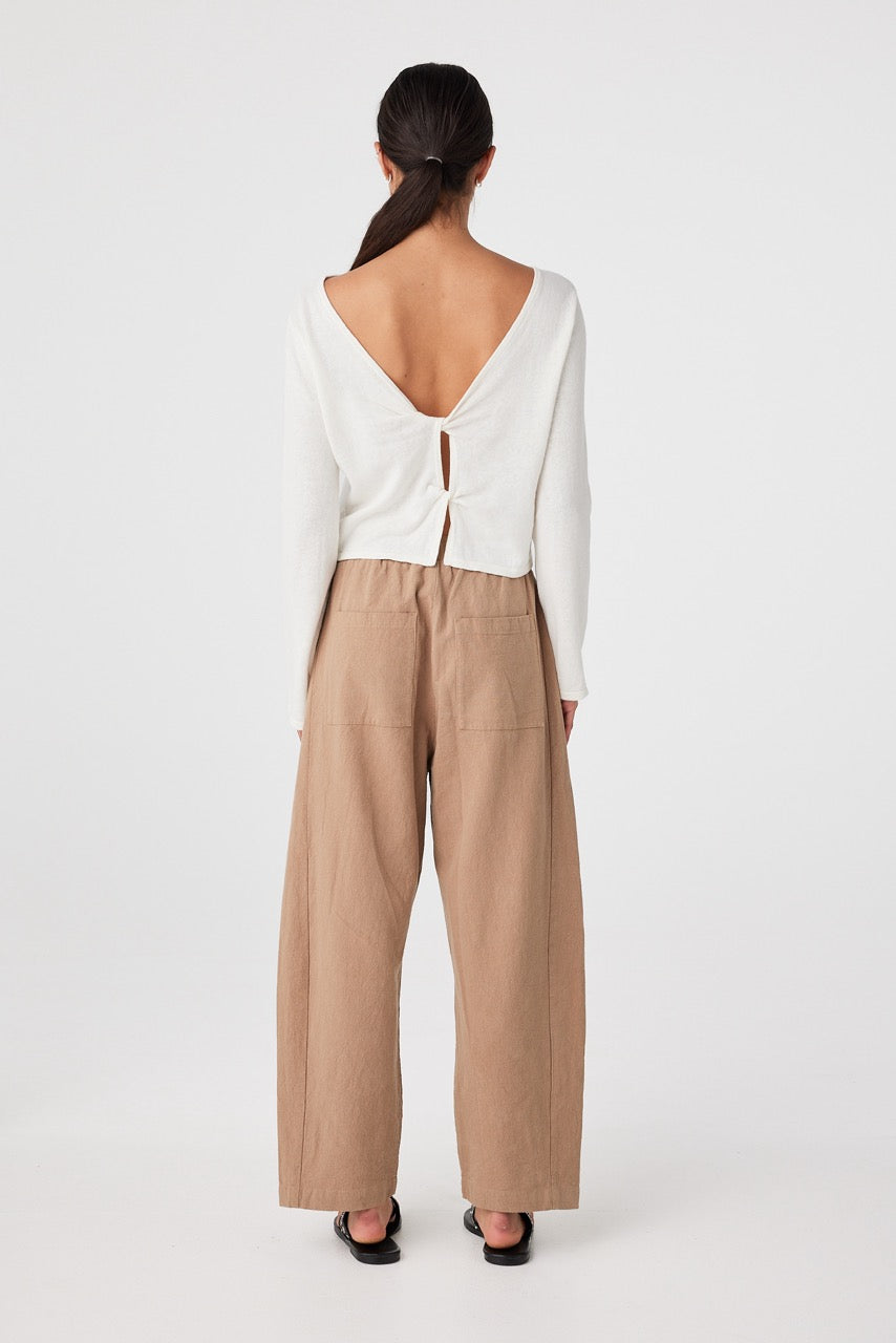 Back view of cream knit with open twist cut-out, showcasing reversible styling detail