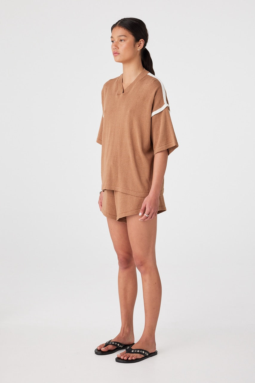 Three-quarter view of pecan-coloured casual shorts styled with oversized knit tee