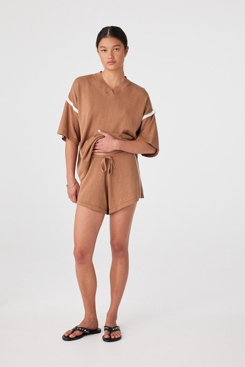 Lifestyle view of relaxed set with drawcord shorts and contrast detail for warm-weather wear