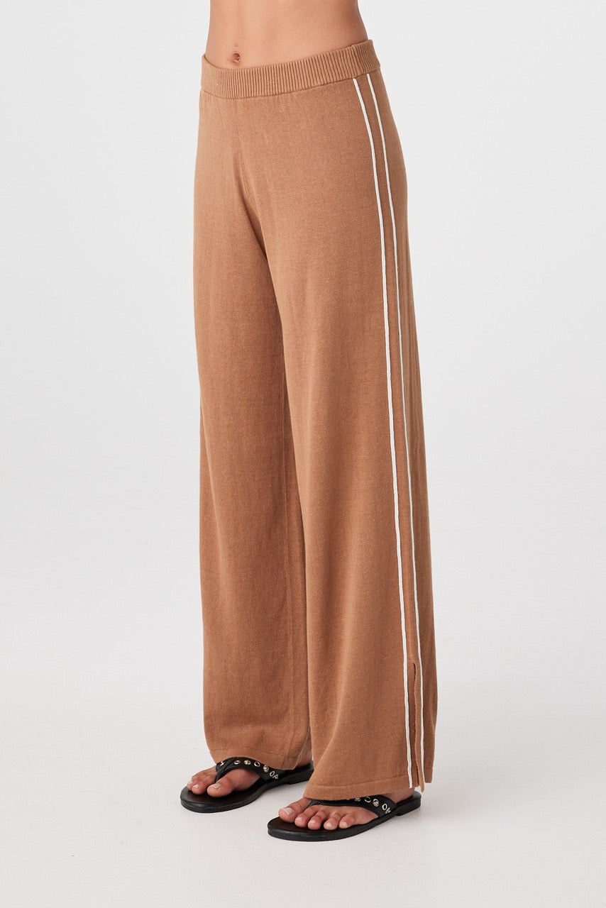 Side view of pecan wide-leg pants with cream side stripe and ankle slit detail