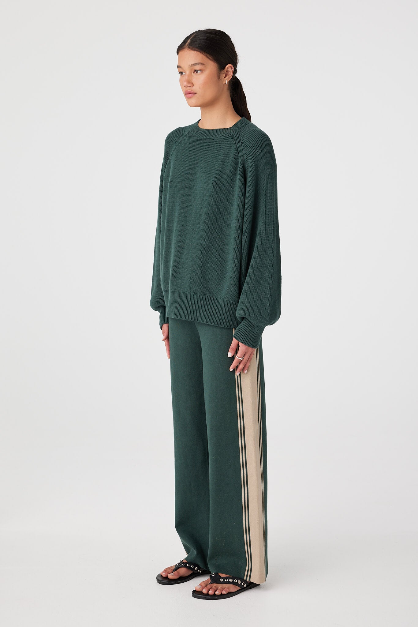 Side view of Forest high-rise pants showing straight leg line and contrasting side stripe down the outer seam