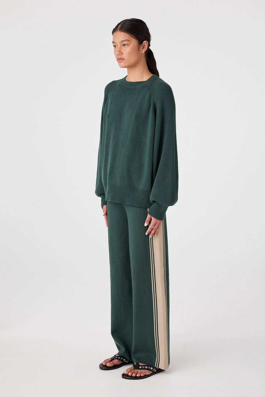 Three-quarter view of Forest chunky rib knit highlighting sleeve volume and rib texture