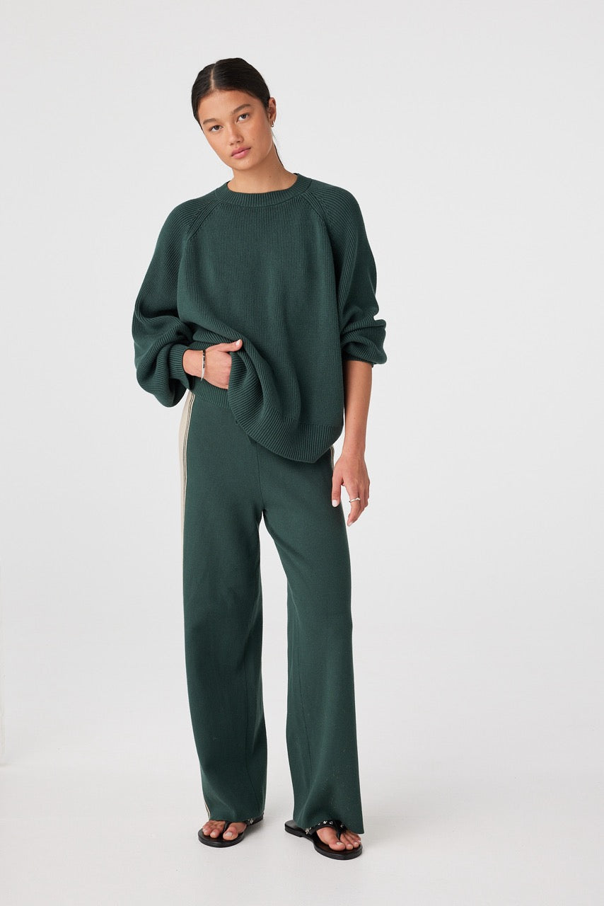 Forest rib knit sweater styled with tonal pants for mild-to-cool coastal weather