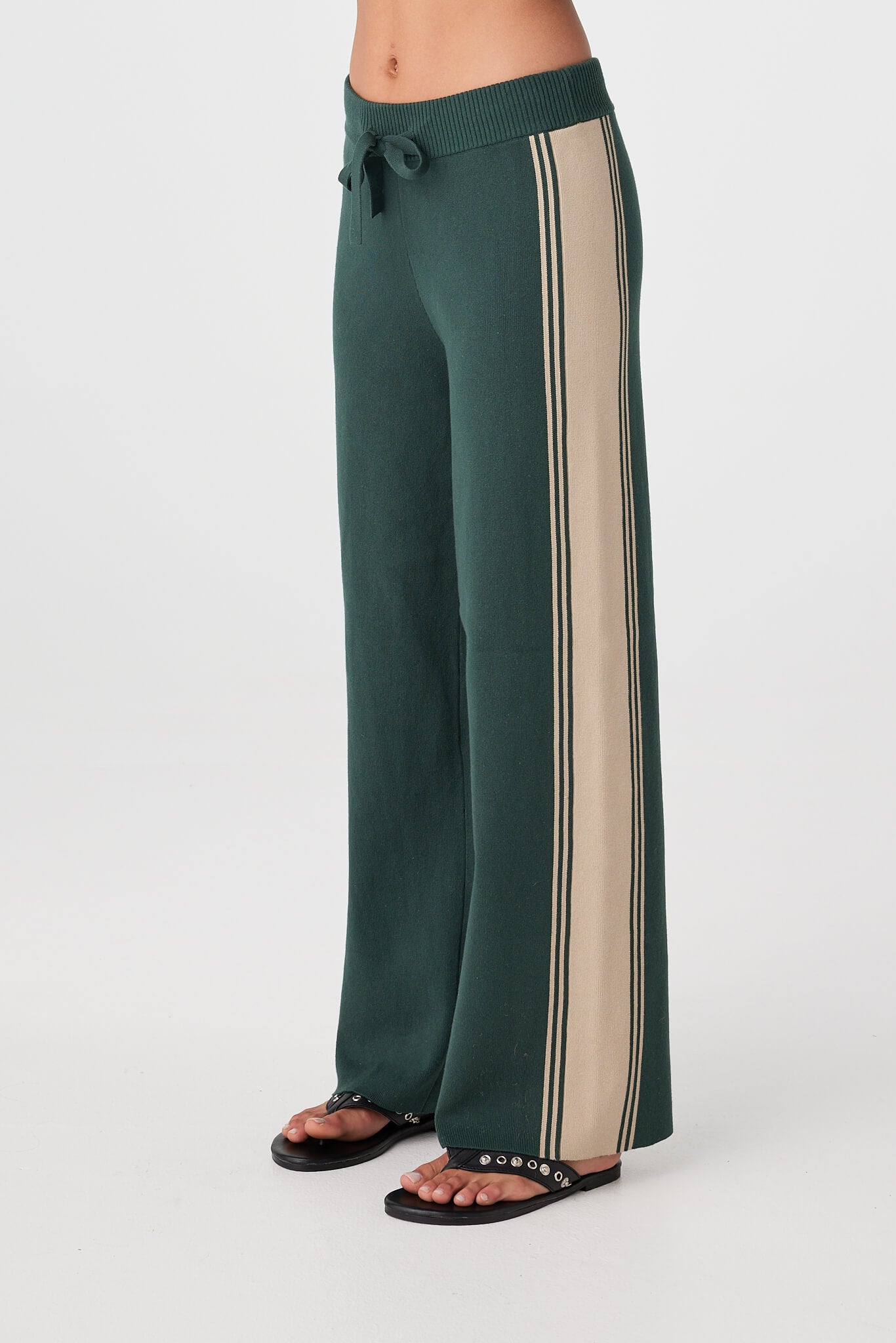 Close view of ribbed waistband with drawcord and contrasting tie on Forest pants