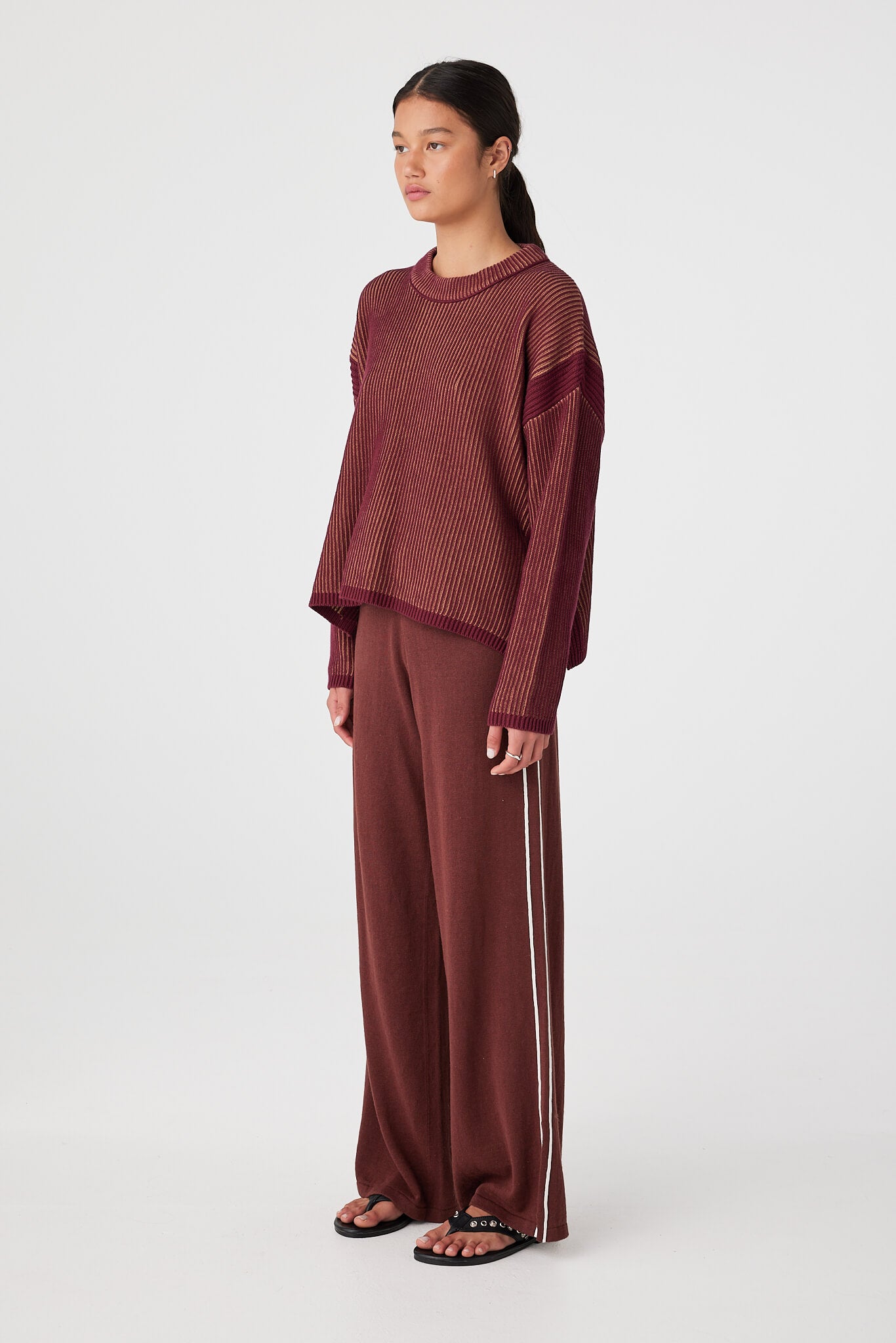 Side view of slouchy rib knit sweater showing cropped length and drape through the body