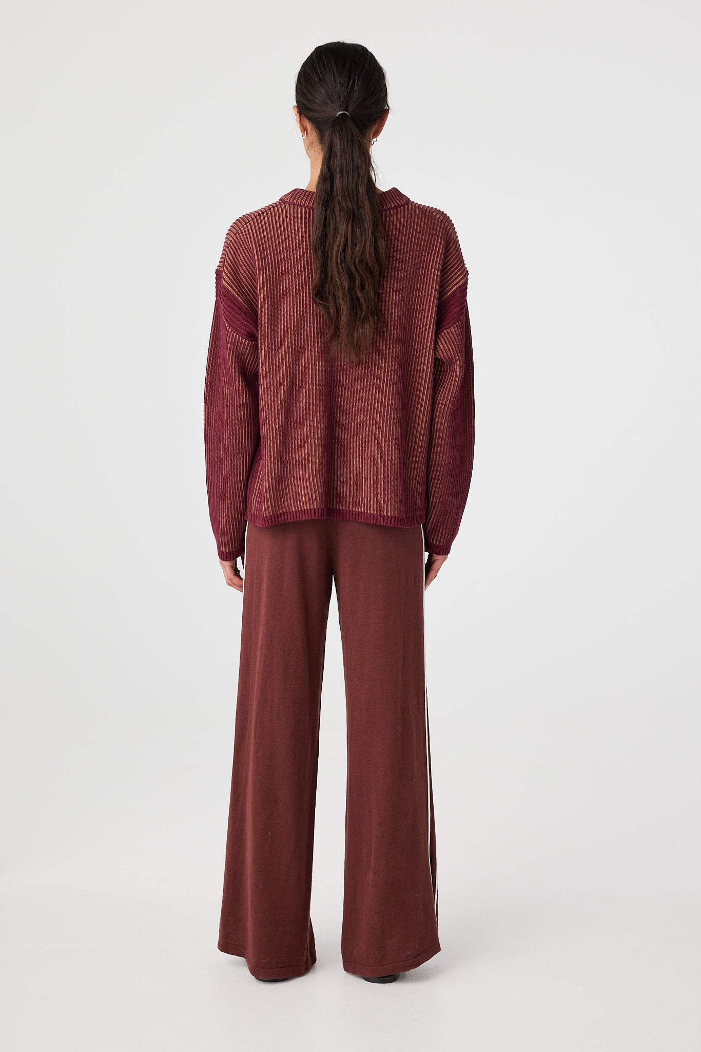 Back view of oversized rib knit sweater showing relaxed fit and two-tone texture placement