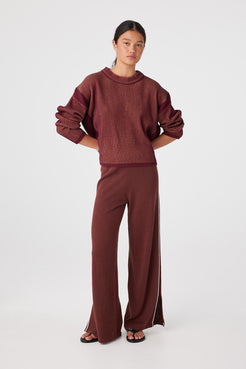 Styled look with matching pants highlighting breathable knit set for mild-to-cool weather