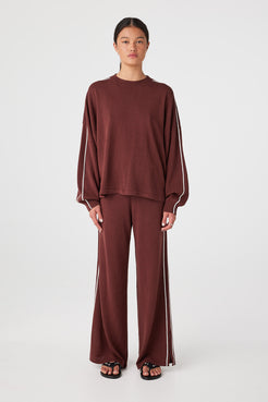 Front view of Raisin & Cream long sleeve knit tee showing relaxed oversized drape and contrast stripe along sleeve