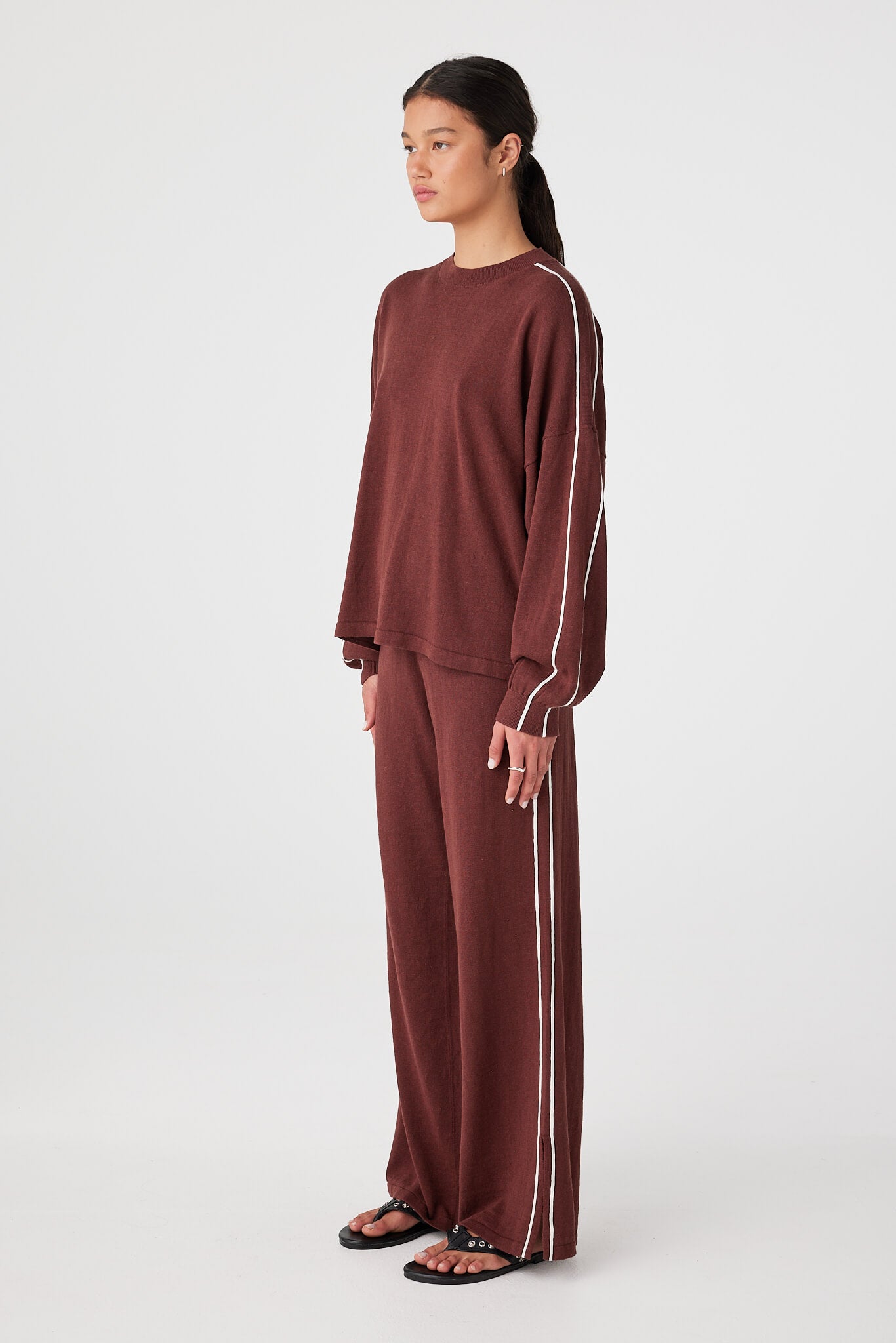 Side view of oversized long sleeve tee showing drop shoulder seam and loose sleeve shape