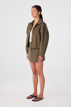 Side view of khaki cotton mini skirt with velvet finish, mini length for warm weather