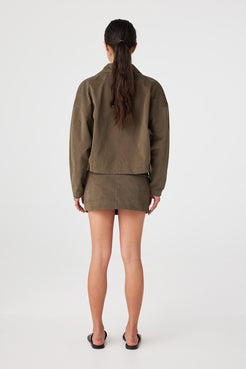 Back view of khaki mini skirt showing clean back and structured cotton finish