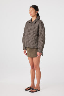 Side view of cocoon sleeve shape on Espresso Check quilted jacket, dropped shoulder for layering room