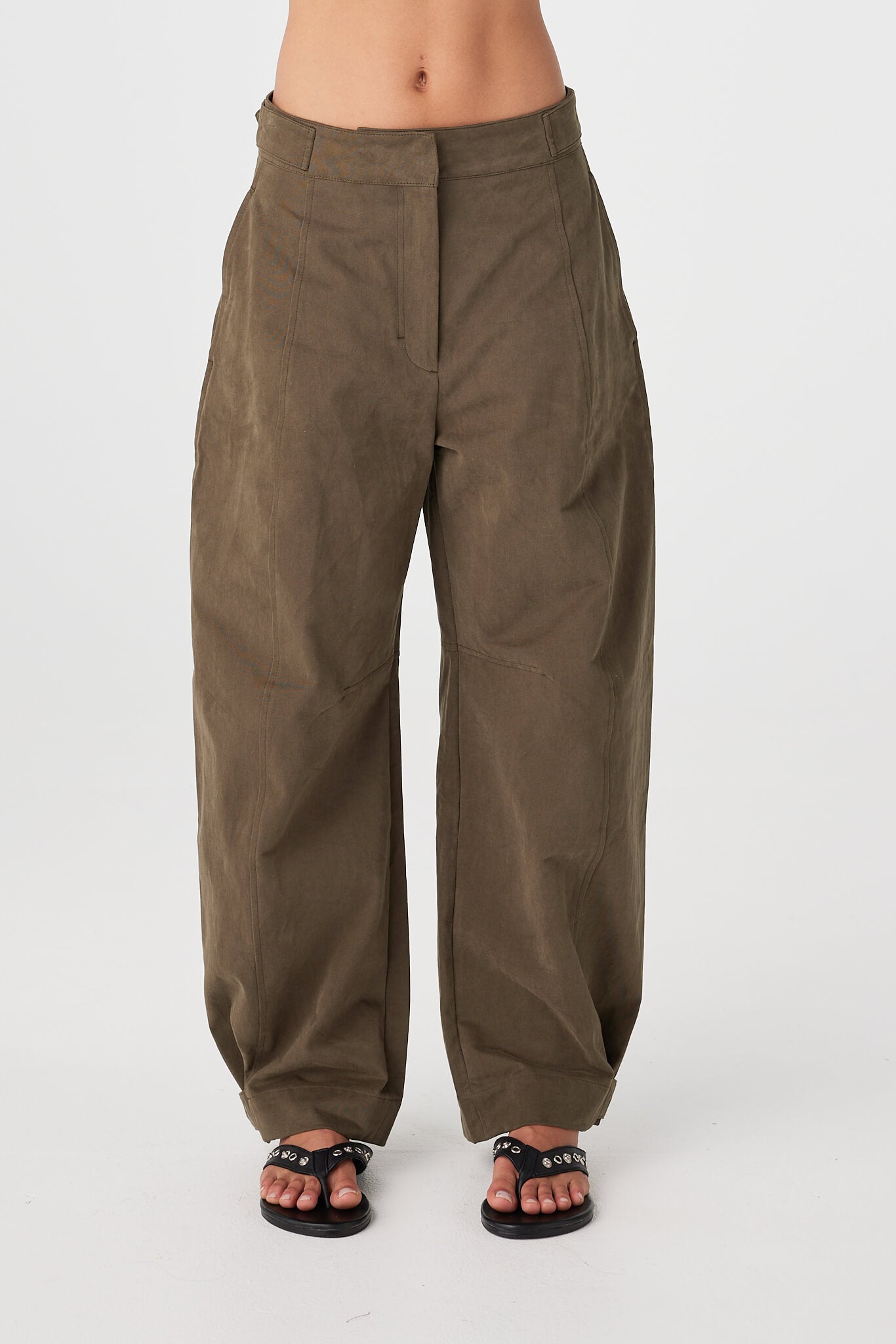 Front view of khaki cotton barrel-leg pants showing structured fit and fly front closure