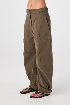 Side view of khaki velvet-finish cotton pants showing barrel silhouette and ankle opening