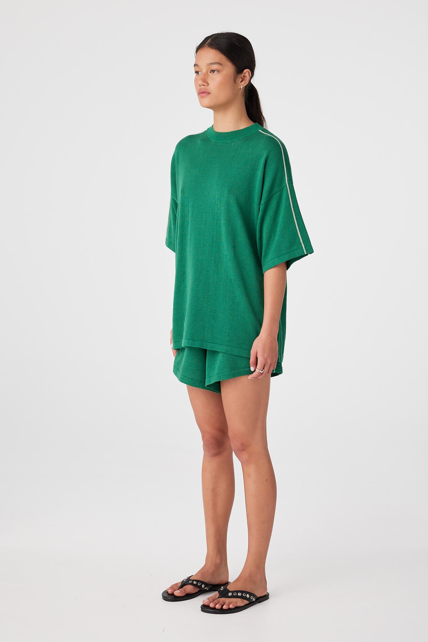 Sea green linen–cotton shorts styled with oversized tee, designed for warm-weather ease