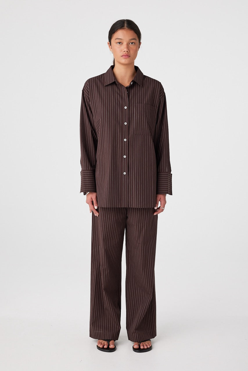 Relaxed cotton pants and shirt set styled for lounge or travel in espresso stripe