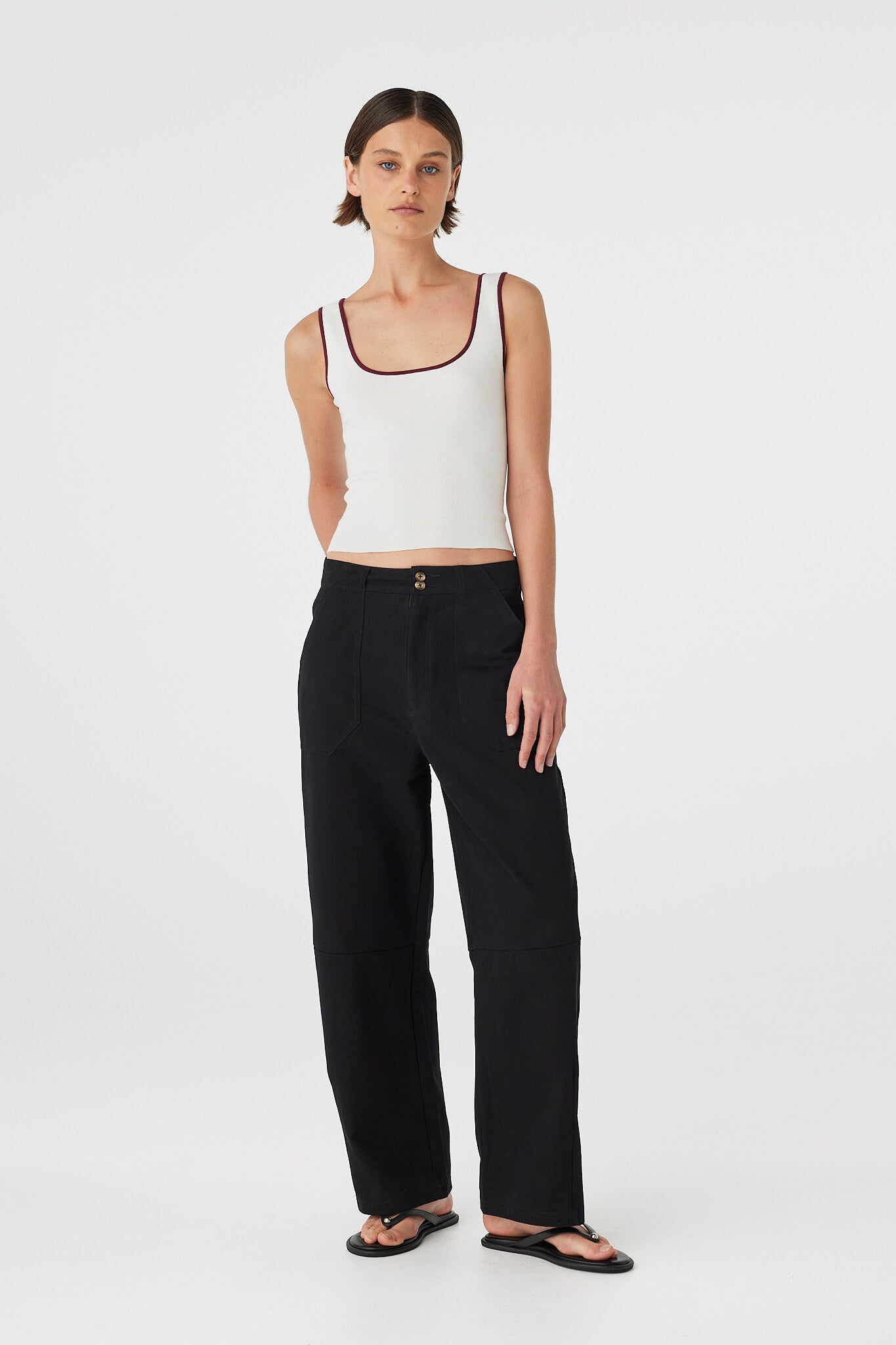 Three-quarter full body view of Kaya Tank cream and merlot, contrast trim detail visible at neckline and armholes.