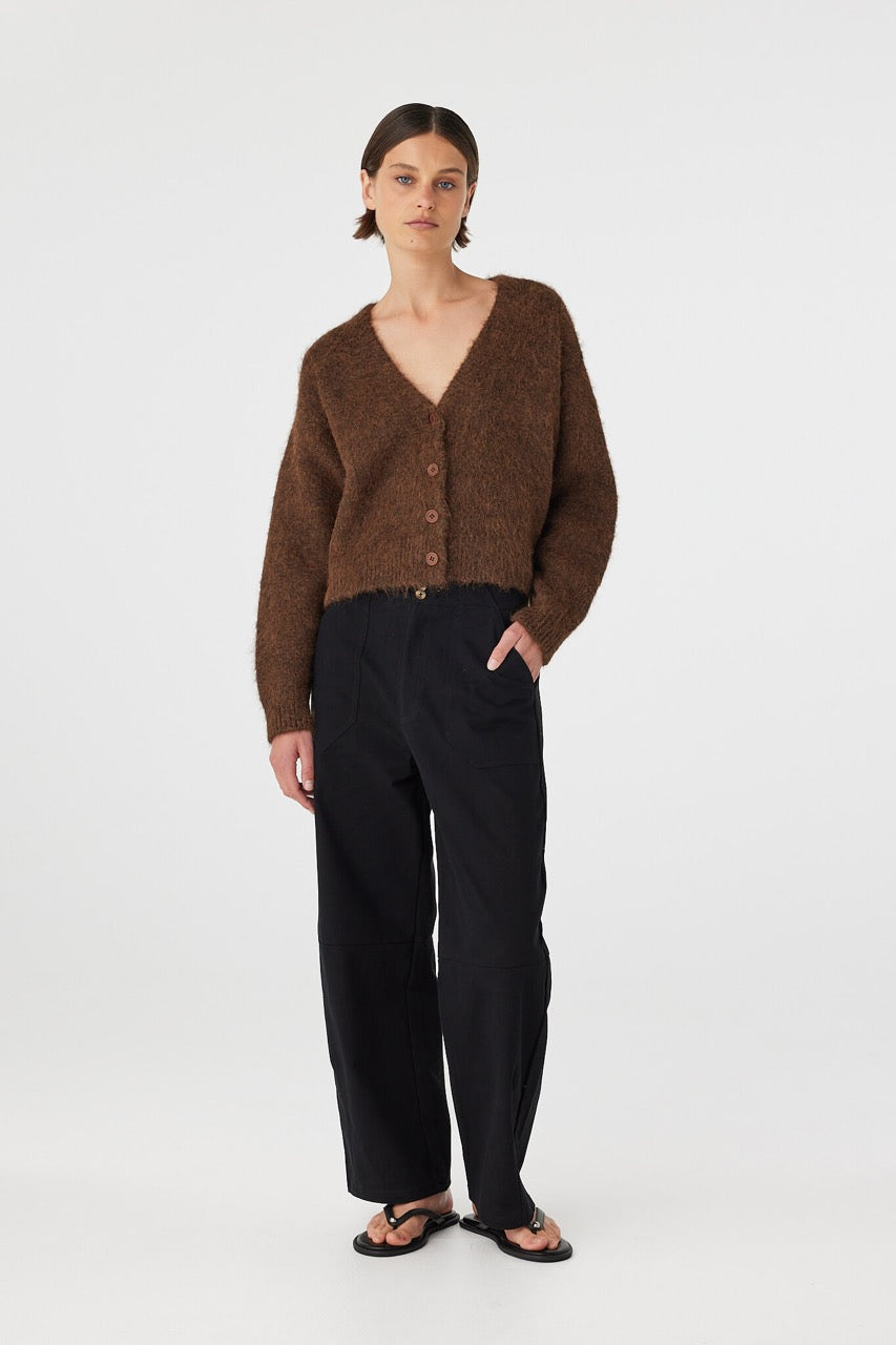 Full body front view of brown cardigan styled with hands in pockets