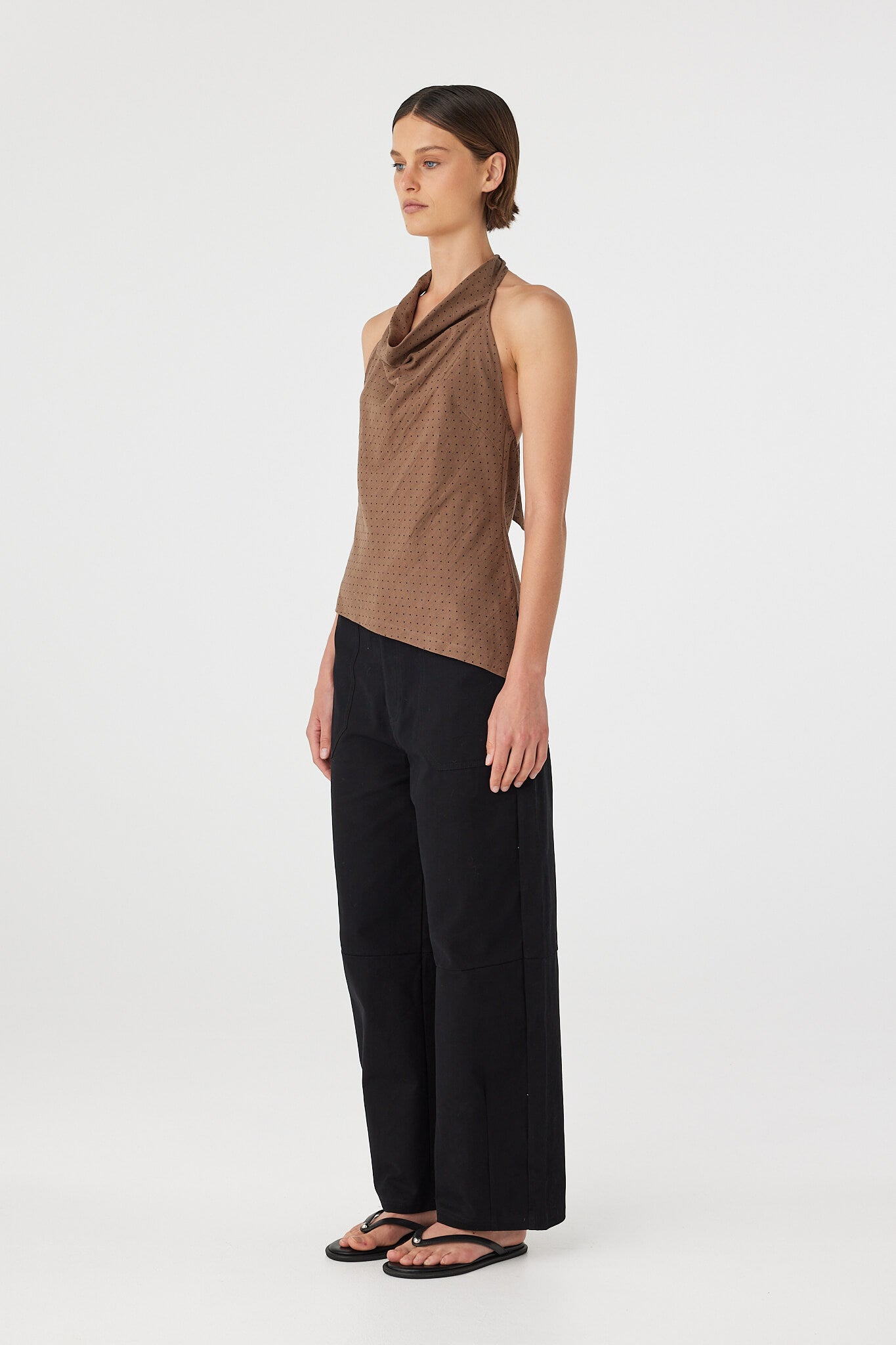 Side view of Alessia Top in choc polka dot, bias-cut cotton halter top with draped neckline and asymmetrical hem.