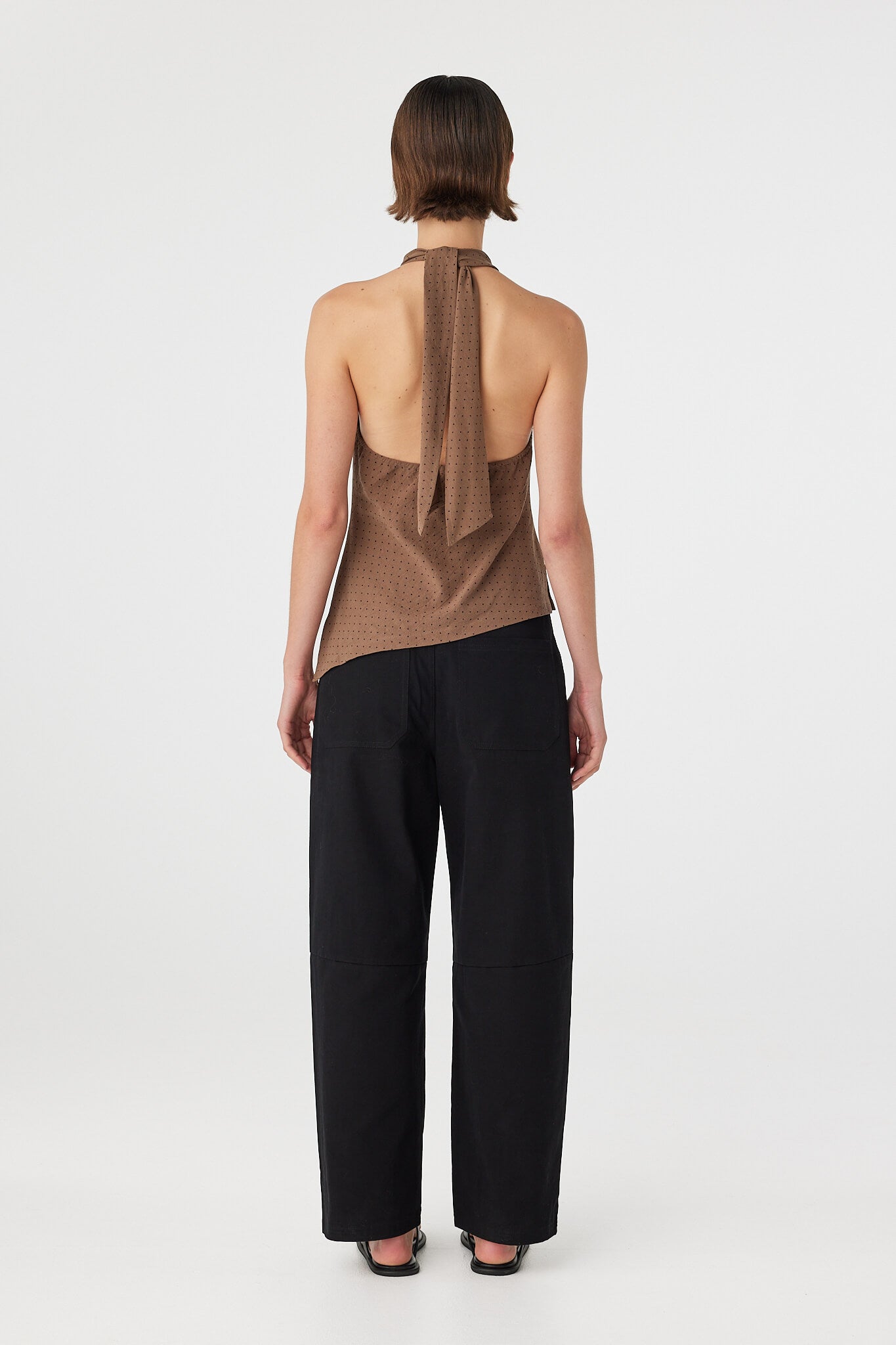 Back view of Alessia Top choc polka dot, low back halter with adjustable tie detail.
