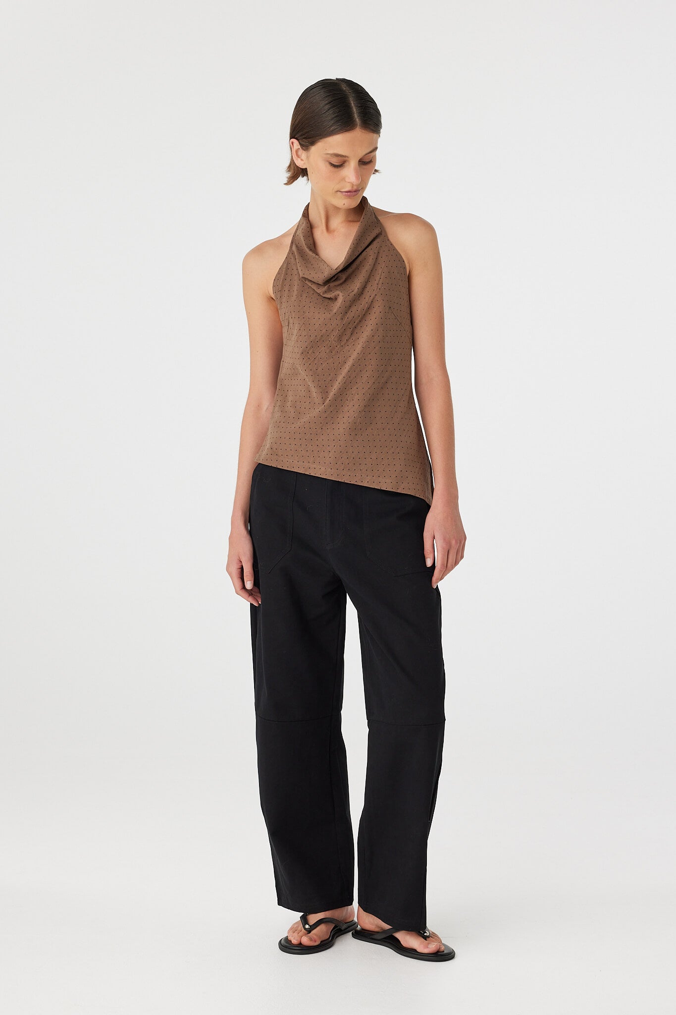 Three-quarter view of Alessia Top in choc polka dot, cotton cowl neck halter showing drape and hem shape.