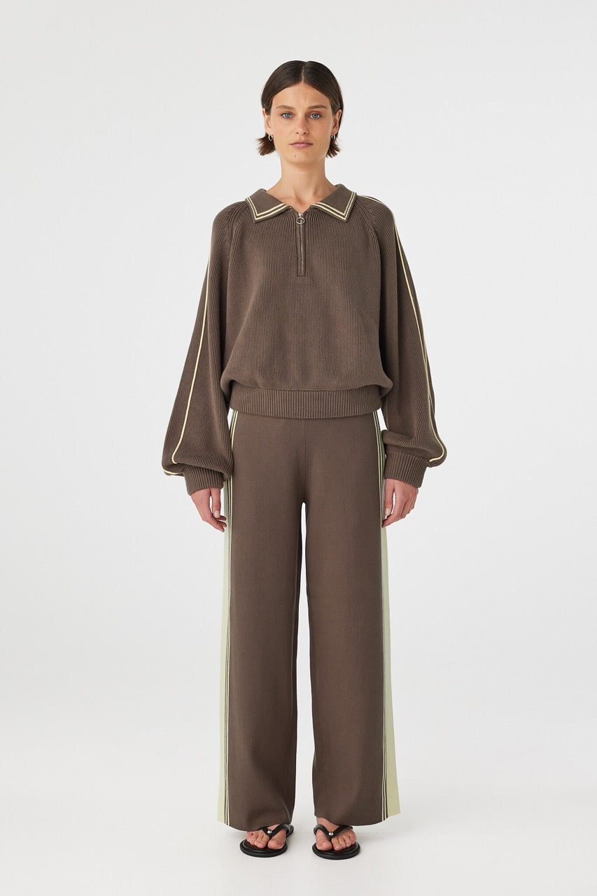 Model wearing Emery Pant in pavement with butter side stripe, high-rise straight leg organic cotton stretch pants with drawcord waist, front view.
