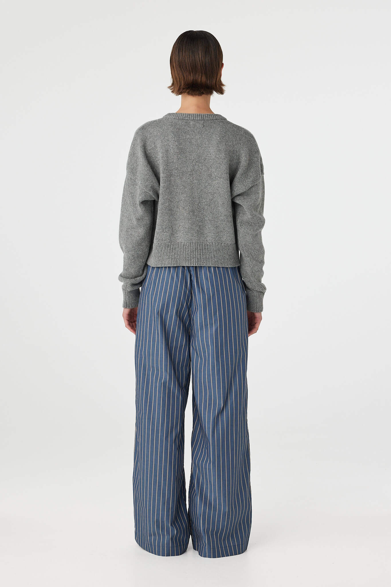 Back view of Bobby Cardigan grey marle, dropped shoulder knit with ribbed hem and cuffs.