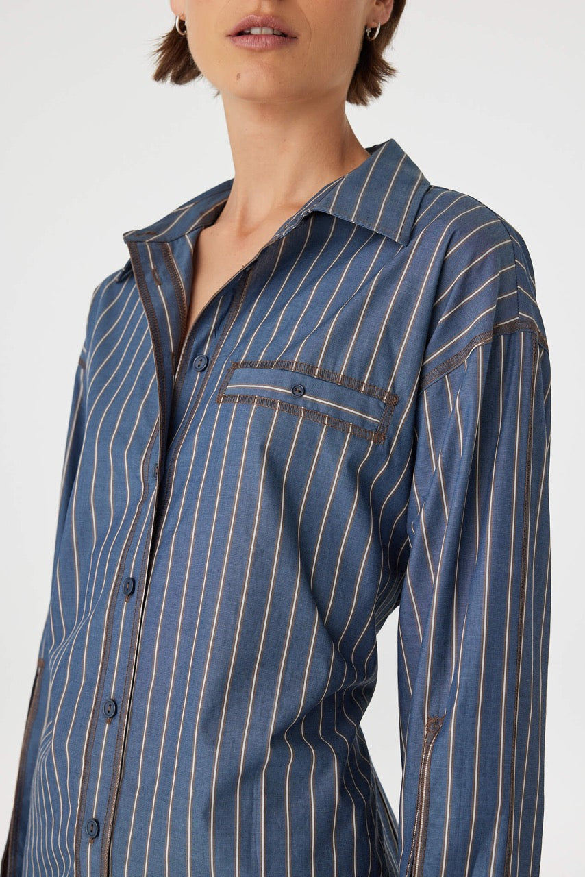 Close front detail of Blair Shirt muted blue stripe, cotton fabric and stripe placement with button placket.