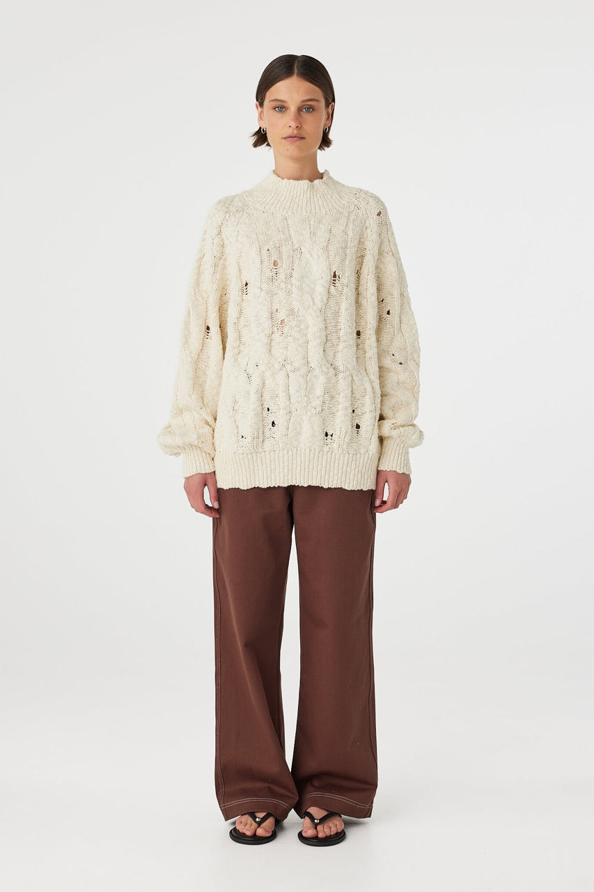 Front view of cream sweater showing relaxed oversized fit