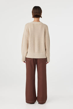 Back view of cream sweater with ribbed hem detail