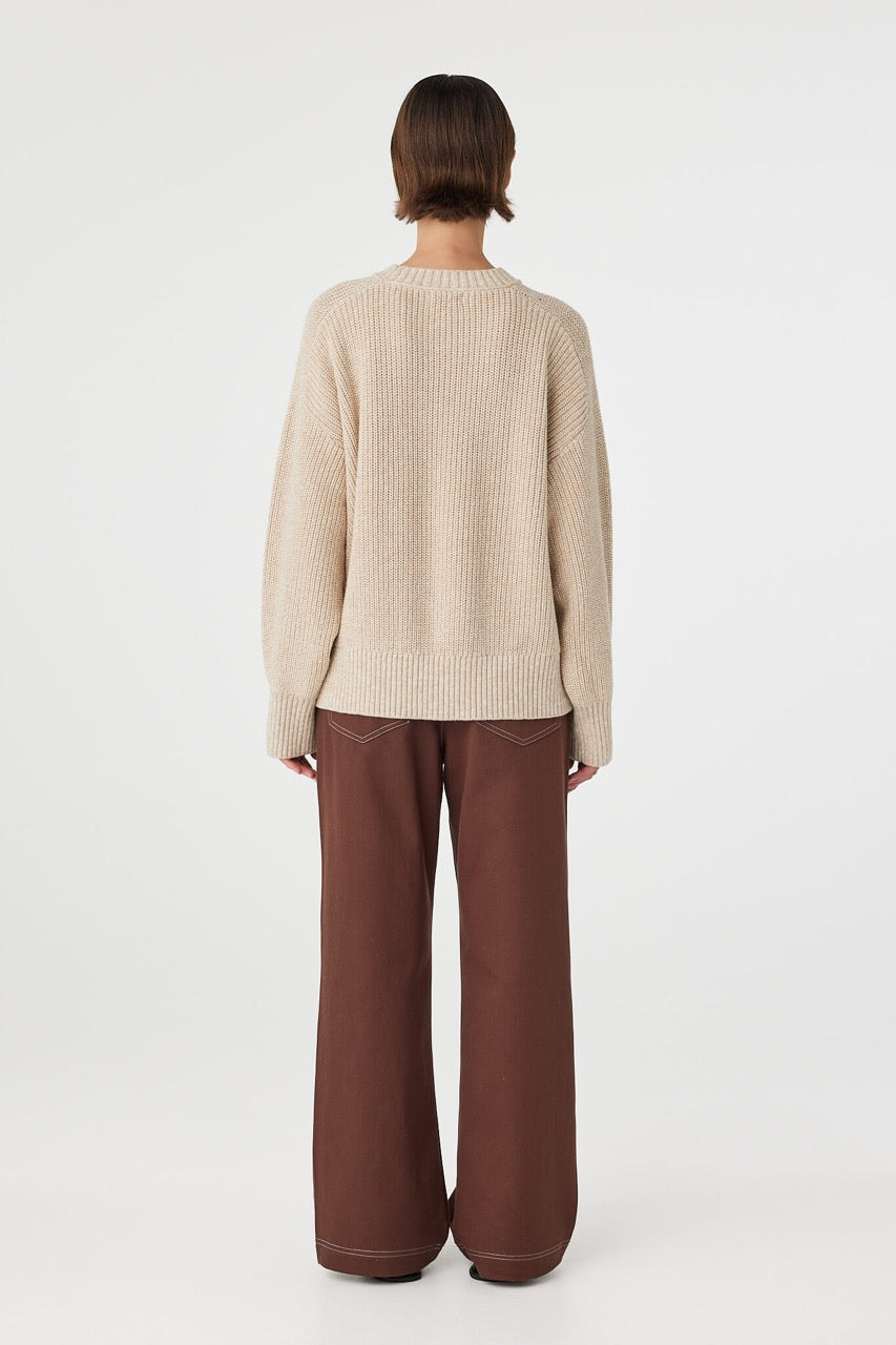 Back view of cream sweater with ribbed hem detail