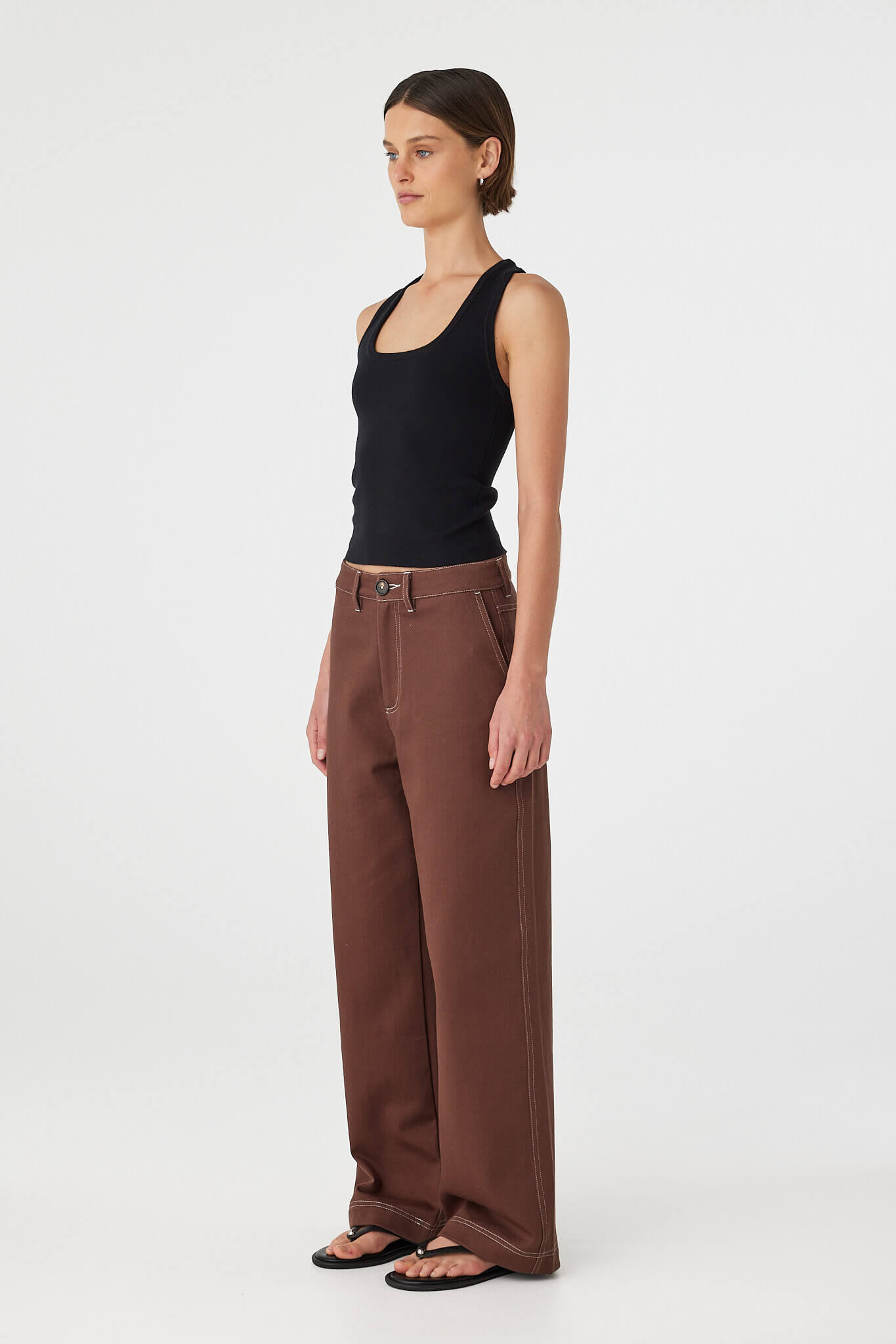 Side view of Sable Top in black, slim-fit scoop neck tank with racerback cut.