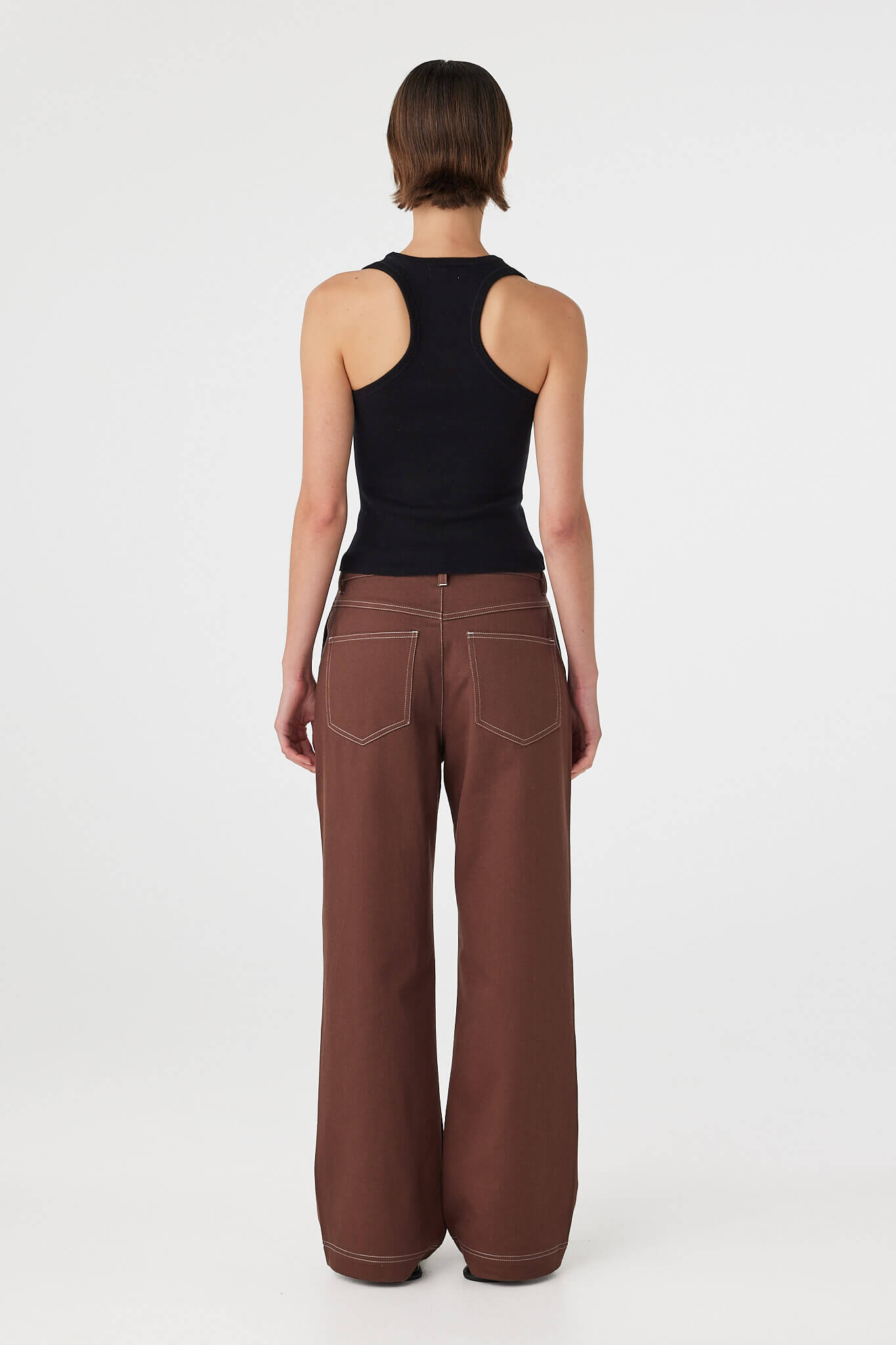 Back view of Sable Top black, racerback silhouette showing shoulder coverage and fit.