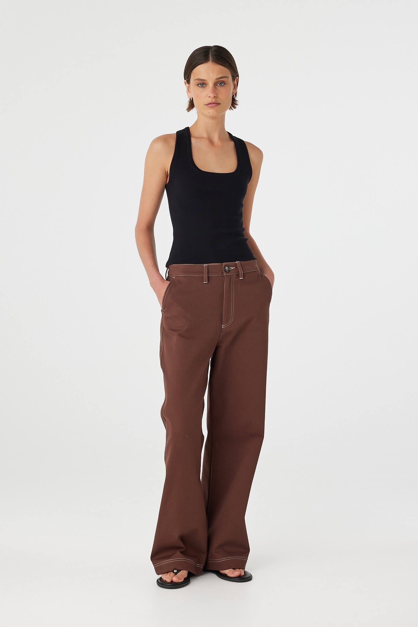 Three-quarter front view of Sable Top black, slim organic cotton stretch tank with scoop neckline.