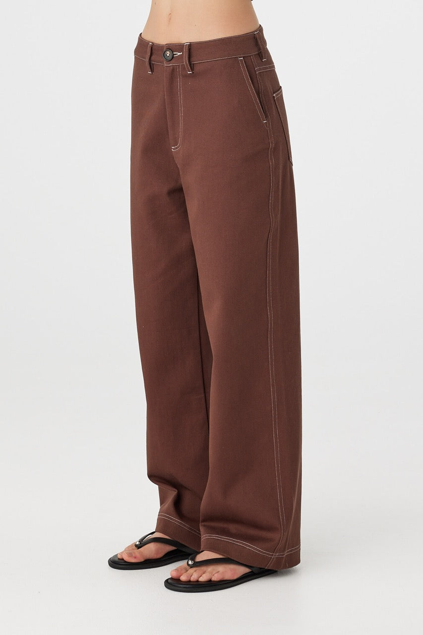 Side view of Tilda Pant in espresso, straight-leg silhouette with contrast stitching and slash pockets.