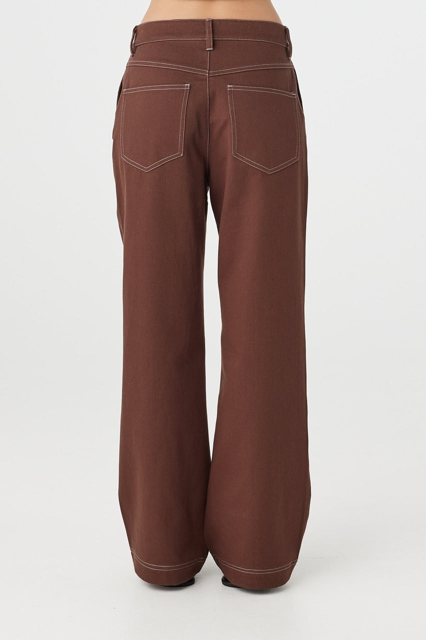 Side view of Tilda Pant in espresso, straight-leg silhouette with contrast stitching and slash pockets.
