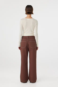 Back view of Aston Long Sleeve Top cream, semi-sheer knit showing close fit through the body.