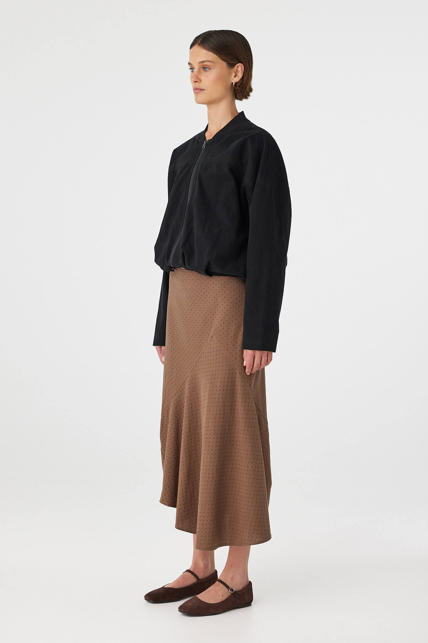 Outfit side view: black top with Alessia Skirt choc polka dot, cotton A-line skirt with asymmetrical hem