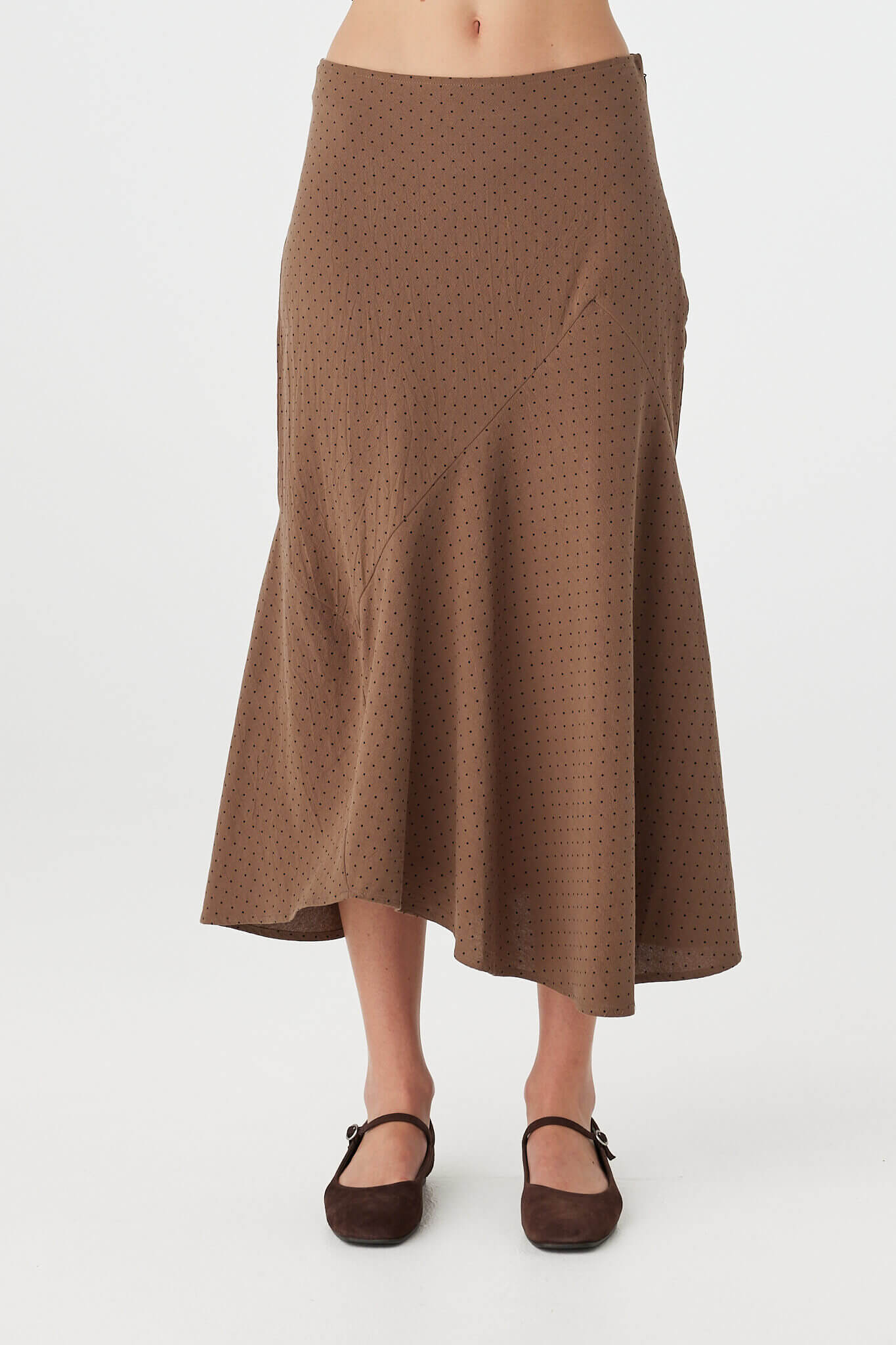 Alessia Skirt choc polka dot cotton A-line skirt, front view showing bias-cut asymmetrical hem movement.