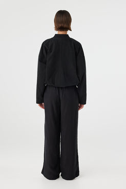 Back view of black bomber jacket with elasticated hem