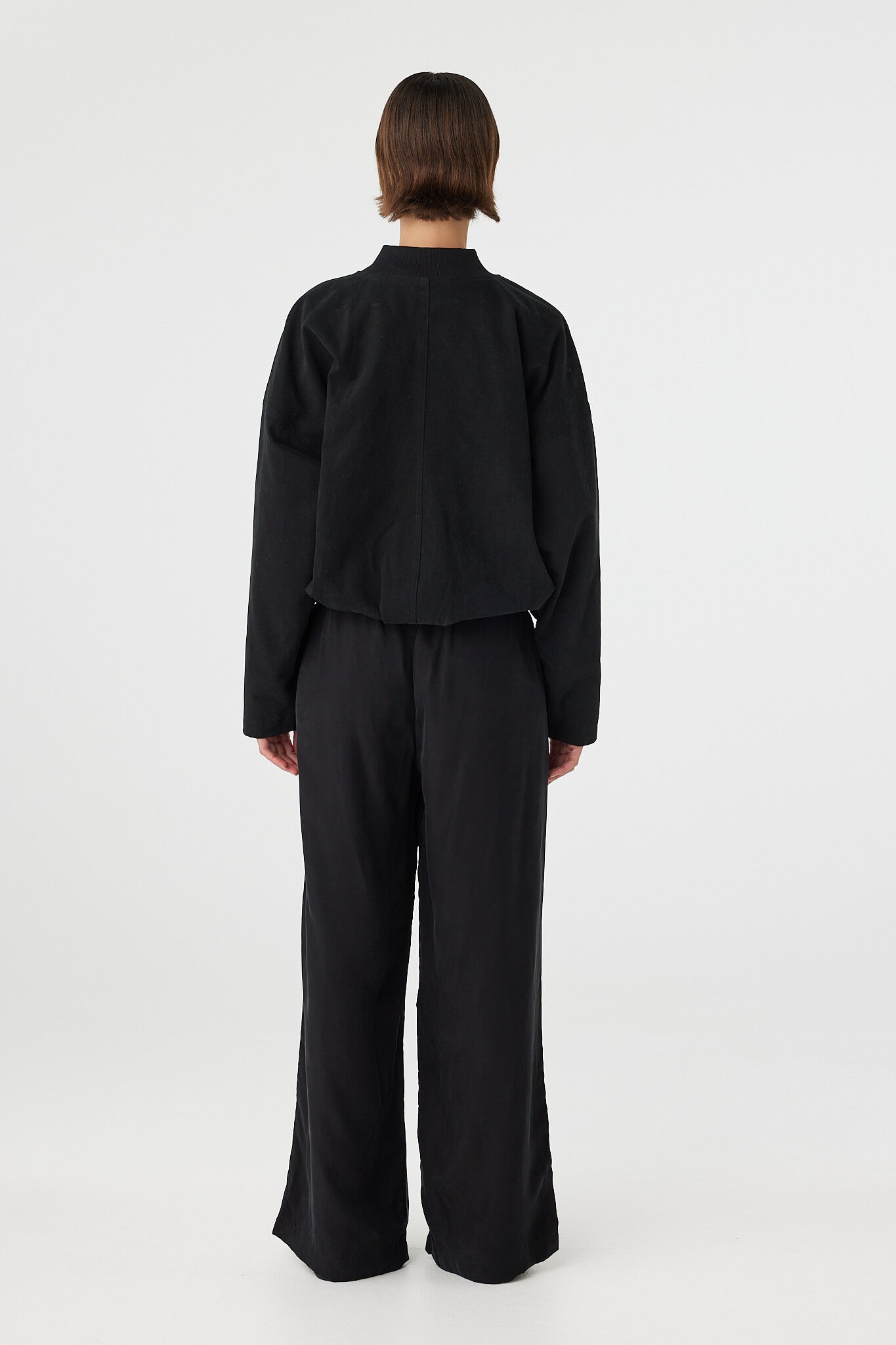 Back view of Rae Pant black, straight-leg drapey pants showing relaxed fit through seat and leg.