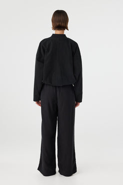 Back view of Rae Pant black, straight-leg drapey pants showing relaxed fit through seat and leg.