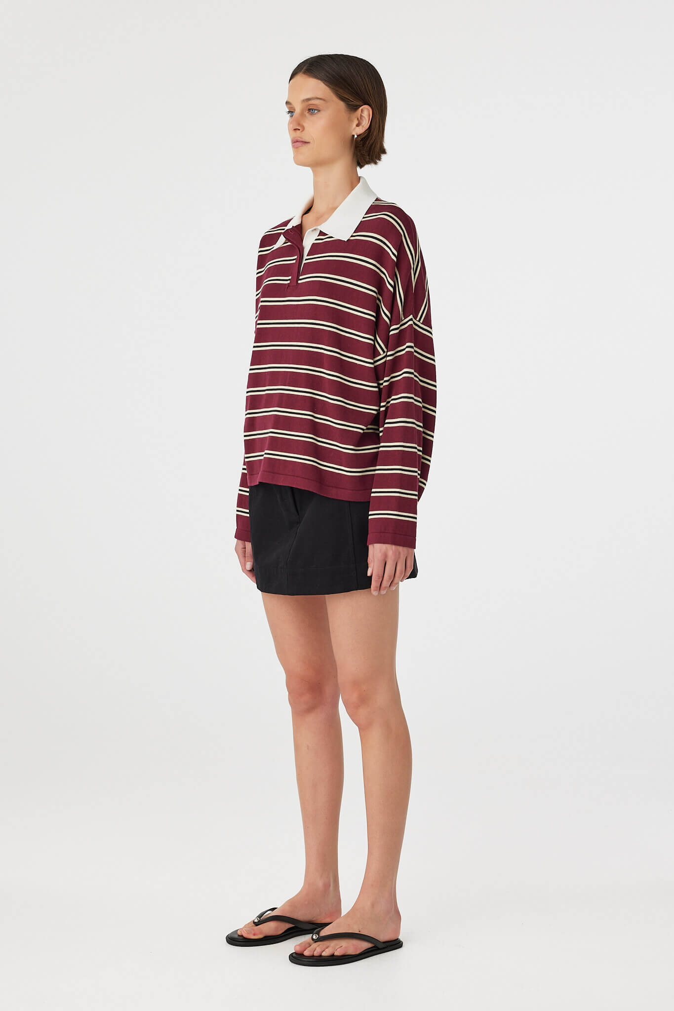 Side view of Eames Mini Skirt in black, cotton mini skirt with side seam pocket and fitted waist.